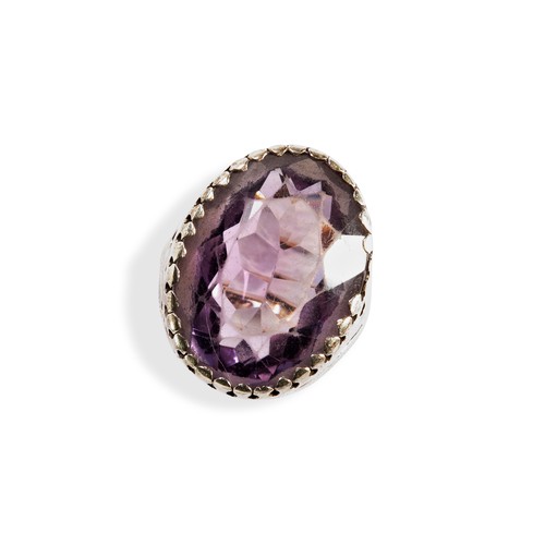 92 - A SINGLE STONE OVAL AMETHYST RINGwith a claw set wit an oval amethyst set in silver on a later gold ... 