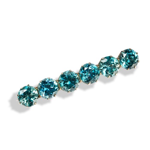 147 - A 20TH CENTURY BLUE ZIRCON BAR BROOCHclaw set with six blue zircons.Unmarked, tests as 14ct goldMeas... 