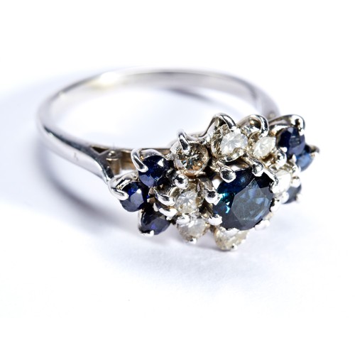 65 - A SAPPHIRE AND DIAMOND SET CLUSTER RINGthe central round cut, claw set, sapphire being surrounded by... 