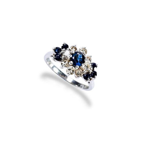 65 - A SAPPHIRE AND DIAMOND SET CLUSTER RINGthe central round cut, claw set, sapphire being surrounded by... 