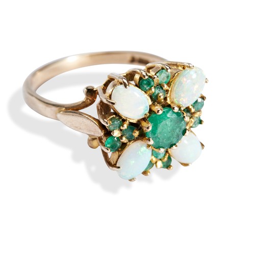 67 - A CONTEMPORARY OPAL AND EMERALD RINGthe central round cut, claw set, emerald surrounded by four oval... 