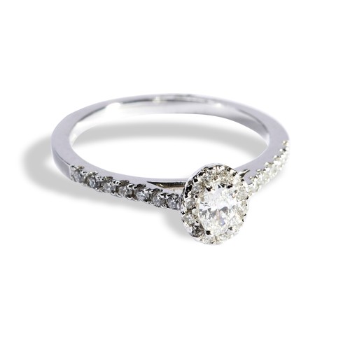 136 - A DIAMOND CLUSTER RINGthe oval mixed-cut diamond within a border of brilliant--cut diamonds, each sh... 