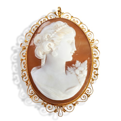 128 - A CAMEO AND GOLD BROOCH/PENDANTa shell cameo of a lady in a yellow gold filigree mount with brooch a... 