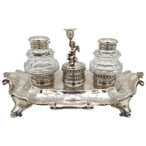 295 - AN ELEGANT SILVER INK STAND, profuse chased foliate decoration with scroll edge, raised on four scro... 