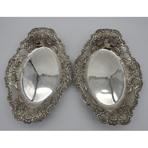 289 - A PAIR OF OVAL SILVER DISHES, scroll foliate repousse decoration with pierced panels, bearing the ma... 