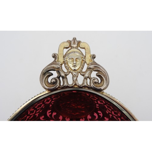 291 - AN UNUSUAL SILVER GILT OVAL BOWL, with cranberry glass liner, pierced scroll work sides emblazoned w... 