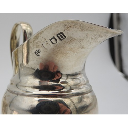 287 - A GEORGE III SILVER CREAMER, with concentric banded waist and gadrooned edge, marked Alice & Geo... 