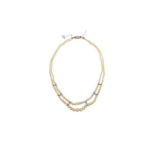 78 - A NATURAL PEARL AND DIAMOND NECKLACEthe two graduating rows of pearls, set to the front with six dia... 