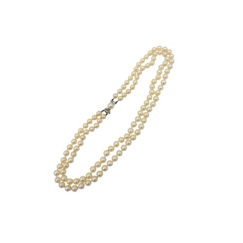 98 - A TWO ROW CULTURED PEARL NECKLACEto a diamond and pearl set bow clasp.Marked 14kPearls measure 0.65c... 