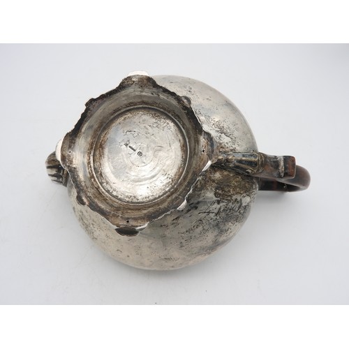 329 - A GERMAN SILVER TEA POT, CIRCA 1860, compressed globular form with scroll spout and wooden scroll ha... 