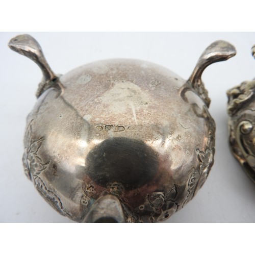 341 - A PAIR OF SILVER PLATED SALTS, gadrooned rims with scroll foliate repousse decoration, raised on thr... 