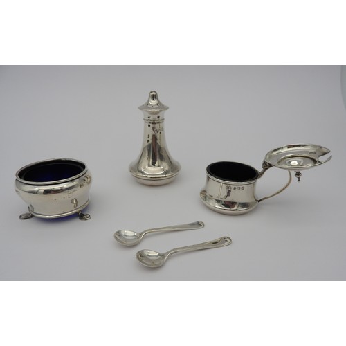 324 - A SILVER CRUET SET, wide waisted tapered form, consisting of a salt cellar with two spoons, a pepper... 