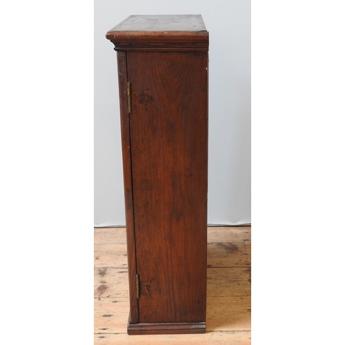 51 - AN OAK CABINET, 19TH CENTURYthe single panelled door enclosing two shelves and six small drawers, wi... 