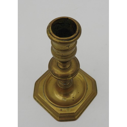 108 - A GEORGE I BRASS CANDLE STICK, EARLY 18TH CENTURY, knopped stem on a square base with canted corners... 