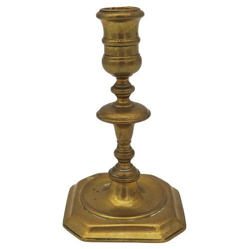 108 - A GEORGE I BRASS CANDLE STICK, EARLY 18TH CENTURY, knopped stem on a square base with canted corners... 