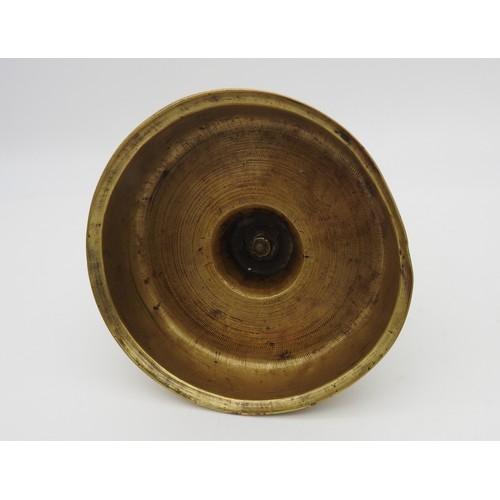 107 - AN 17TH CENTURY CONTINENTAL BRASS CANDLESTICK, probably Dutch, on a distinctive bell shape base21 cm... 