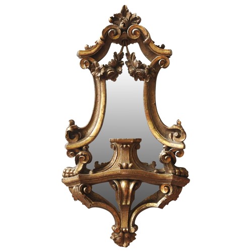 100 - AN ITALIAN GILT WOOD CARTOUCHE MIRROR, EARLY 19TH CENTURYelaborate rococo style scroll work frame de... 