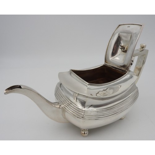 346 - A GEORGE III SILVER TEAPOT, CIRCA 1810boat shape form with fluted waist and elegant curved spout, ra... 