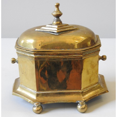 207 - AN EARLY 19TH CENTURY DUTCH BRASS TOBACCO BOX, octagonal shaped sarcophagus form, the domed lid surm... 