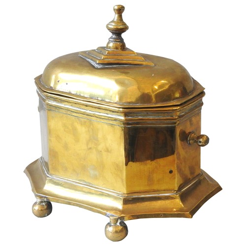 207 - AN EARLY 19TH CENTURY DUTCH BRASS TOBACCO BOX, octagonal shaped sarcophagus form, the domed lid surm... 