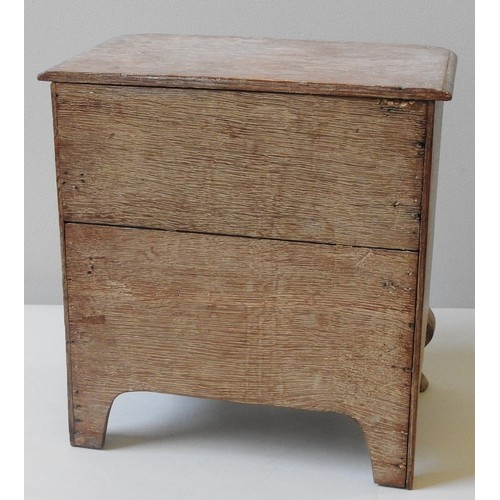 66 - A LIMED OAK MINIATURE CHEST OF DRAWERS, LATE 19TH/EARLY 20TH CENTURY, moulded edge top above three d... 