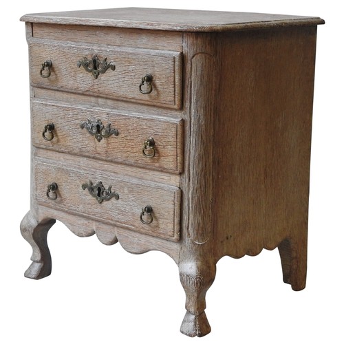 66 - A LIMED OAK MINIATURE CHEST OF DRAWERS, LATE 19TH/EARLY 20TH CENTURY, moulded edge top above three d... 