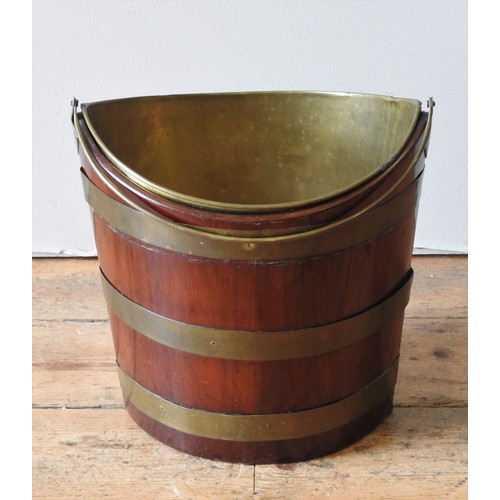 84 - A GEORGE III MAHOGANY BRASS BOUND OYSTER BUCKET, CIRCA 1780, navette form, with swing handle and rem... 