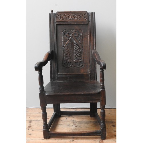 76 - A CHARLES II OAK WAINSCOT CHAIR, CIRCA 1660, with channelled frames, top rail carved with scrolling ... 