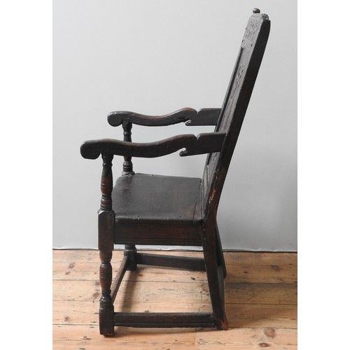 76 - A CHARLES II OAK WAINSCOT CHAIR, CIRCA 1660, with channelled frames, top rail carved with scrolling ... 