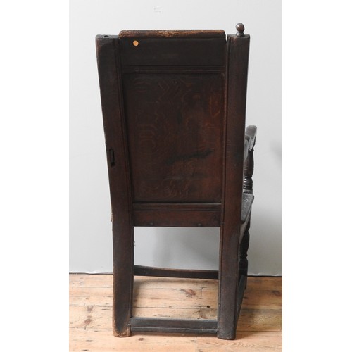 76 - A CHARLES II OAK WAINSCOT CHAIR, CIRCA 1660, with channelled frames, top rail carved with scrolling ... 