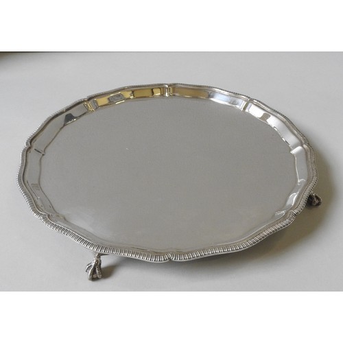 345 - A LARGE SILVER SALVER BY MAPPIN & WEBB, circular form with gadrooned scroll foliate rim, raised ... 