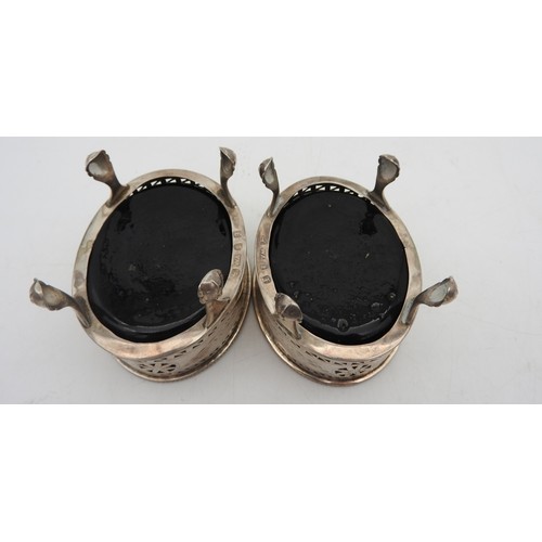 327 - A PAIR OF GEORGE III OVAL SILVER SALTS, with blue glass liners, beaded rims, chased foliate garland ... 