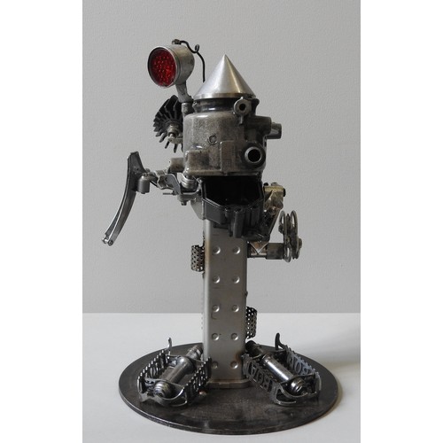 381 - IN THE MANNER OF JOE RUSH, A SCRAP METAL SCULPTURE BY IAN COILEY, a figure with 'pedal' feet, mounte... 