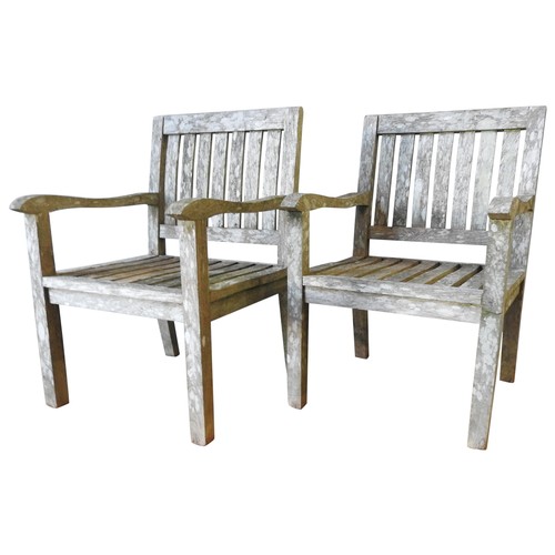 384 - A PAIR OF HARDWOOD GARDEN CHAIRS, slatted back panels with gently swept arm supports, attractive wor... 