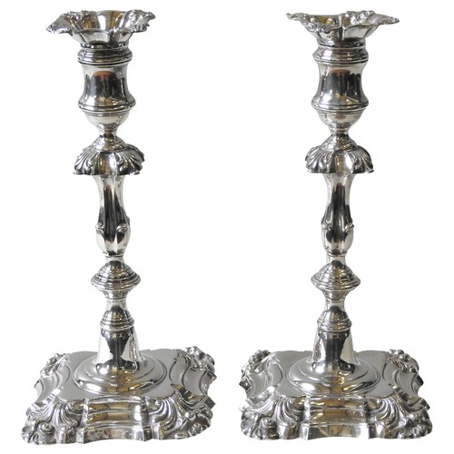 349 - A PAIR OF WILLIAM IV SILVER CANDLESTICKS, campana form sconces sat atop knopped, foliate banded stem... 