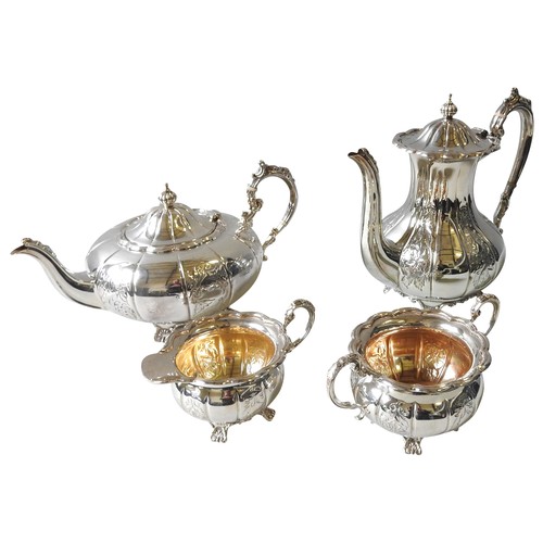 348 - A SILVER FOUR PIECE TEA SERVICE, compressed melon form with alternating repousse decoration depictin... 