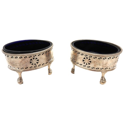 327 - A PAIR OF GEORGE III OVAL SILVER SALTS, with blue glass liners, beaded rims, chased foliate garland ... 