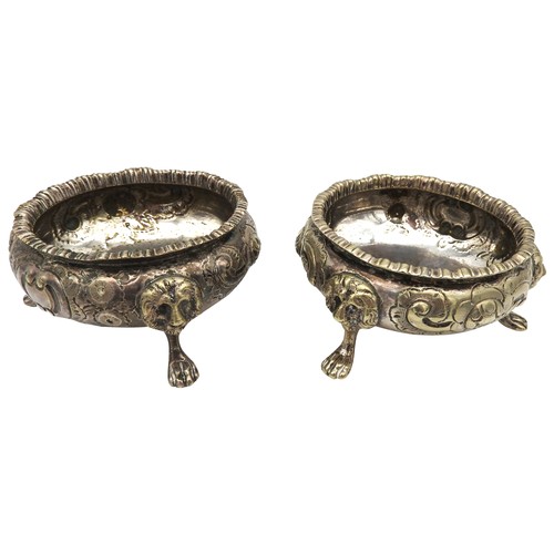 341 - A PAIR OF SILVER PLATED SALTS, gadrooned rims with scroll foliate repousse decoration, raised on thr... 