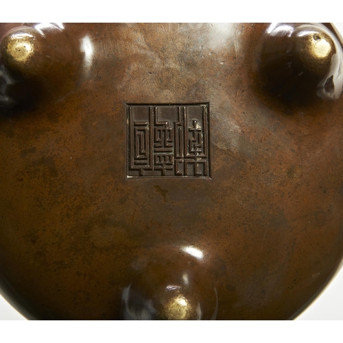 22 - A BRONZE TRIPOD CENSERXUANDE SEAL MARK, 17TH / 18TH CENTURYof compressed globular form raised on thr... 