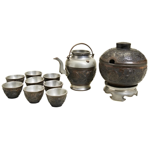 360 - A CARVED COCONUT AND PEWTER TEA SETLATE QING DYNASTYcomprising a covered bowl with stand a teapot an... 