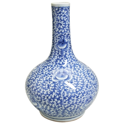 129 - A BLUE AND WHTE BOTTLE VASELATE QING DYNASTY the baluster sides painted with scrolling lotus blooms ... 