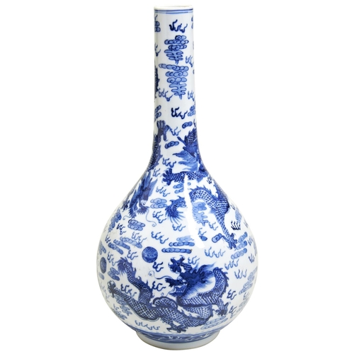 132 - A BLUE AND WHITE 'DRAGON' BOTTLE VASELATE QING DYNASTYthe sides painted in tones of underglaze blue ... 