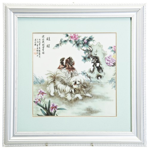 230 - TWO CHINESE PORCELAIN PLAQUES20TH CENTURYeach painted with two playful dogs beside blossoming rockwo... 