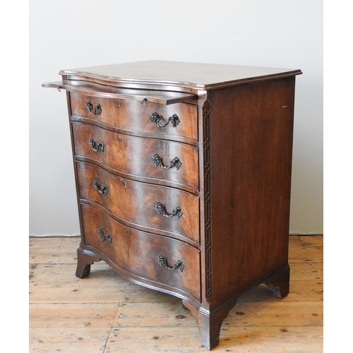 28 - A MAHOGANY SERPENTINE CHEST OF DRAWERS, CIRCA 1920, with a brushing slide above four graduated long ... 