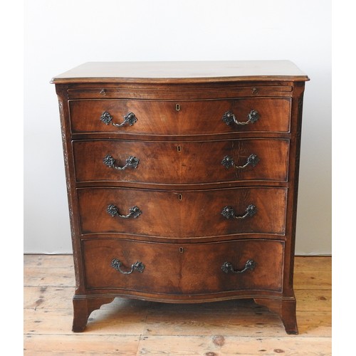 28 - A MAHOGANY SERPENTINE CHEST OF DRAWERS, CIRCA 1920, with a brushing slide above four graduated long ... 