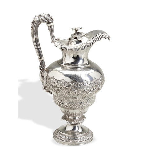 111 - AN ANGLO-INDIAN CLARET JUG C.1860. A double baluster shape claret jug, heavily embossed and chased w... 