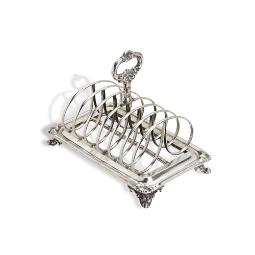 113 - AN ANGLO-INDIAN TOAST RACK CALCUTTA C.1840. A six division toast rack on four cast scroll feet benea... 