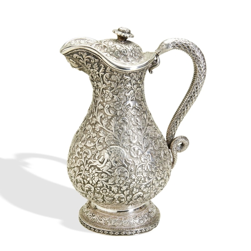 137 - A KUTCH SILVER CLARET JUG, INDIA C.1880. A heavy and well made jug with a snake handle and hinged li... 