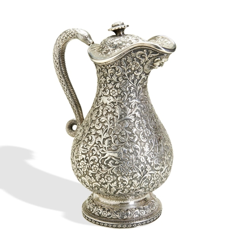 137 - A KUTCH SILVER CLARET JUG, INDIA C.1880. A heavy and well made jug with a snake handle and hinged li... 