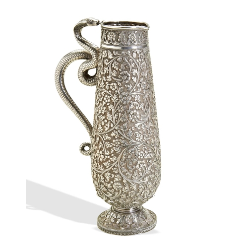 143 - A LARGE KUTCH SILVER JUG WITH SNAKE HANDLE C.1880. A heavy and well chased jug from the town of Bhuj... 